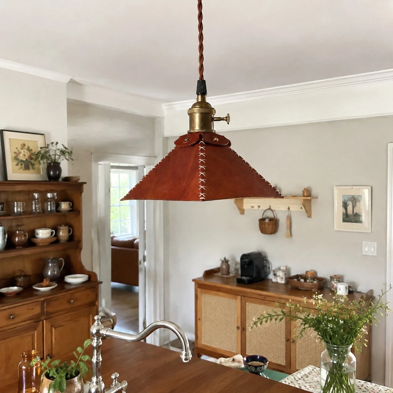 Leather pyramid pendant lamp above a kitchen dining counter