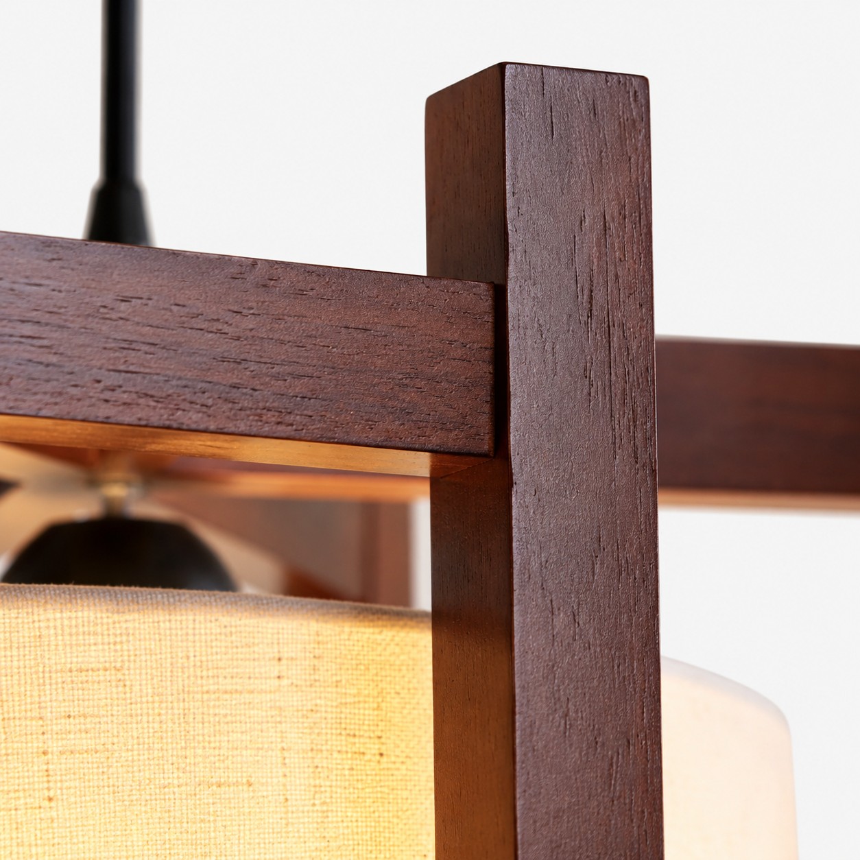 Close-up of walnut finish frame grain and fabric shade