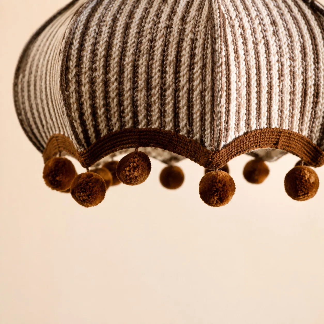 Woven striped fabric shade and pom-pom trim detail