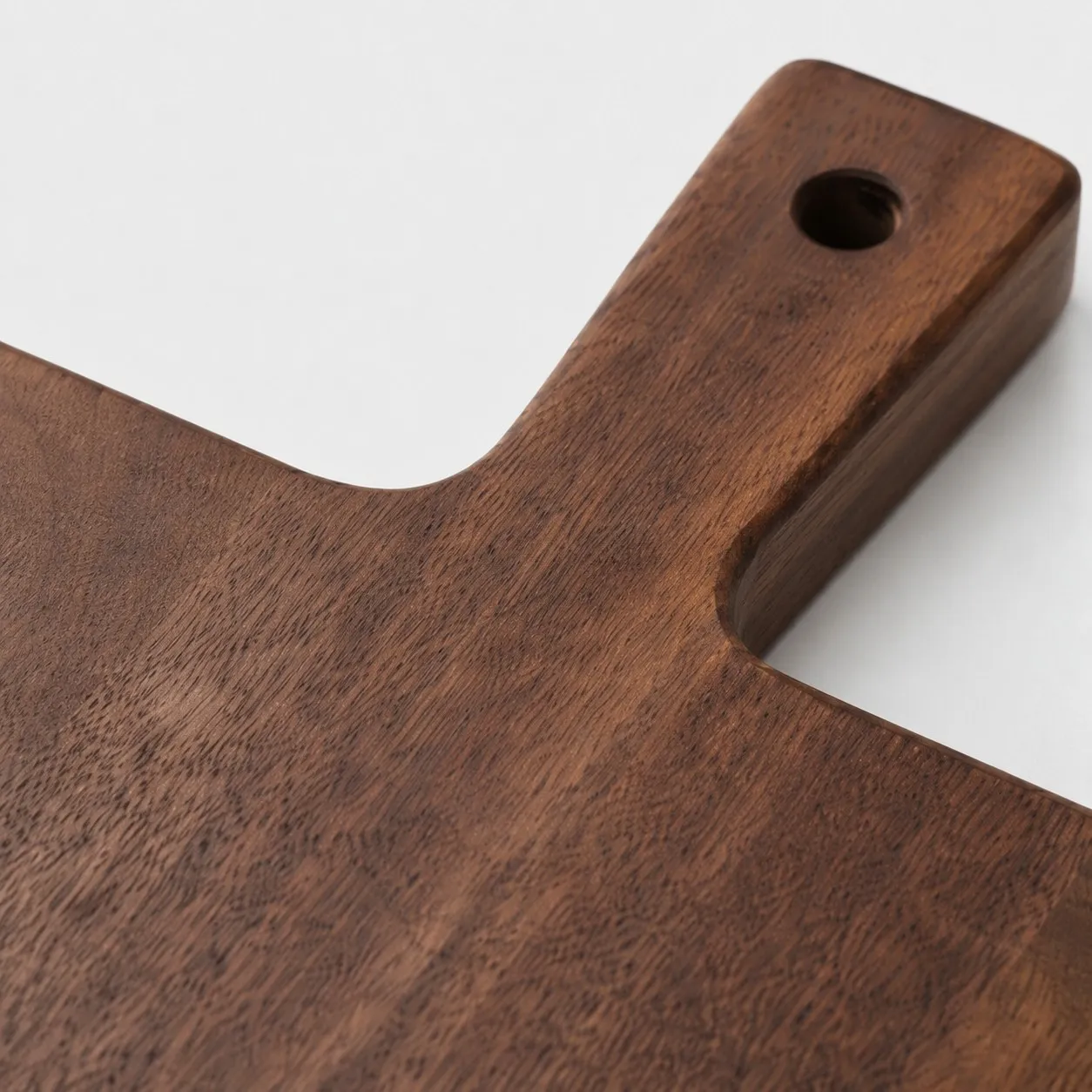 Close view of the cutting board handle and wood grain