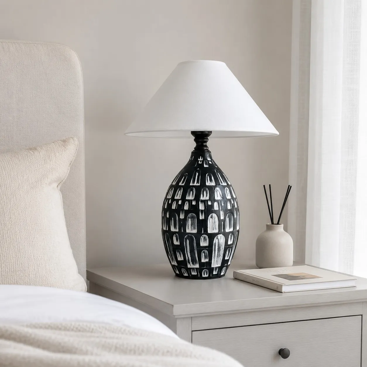 Black ceramic table lamp on a bedside table
