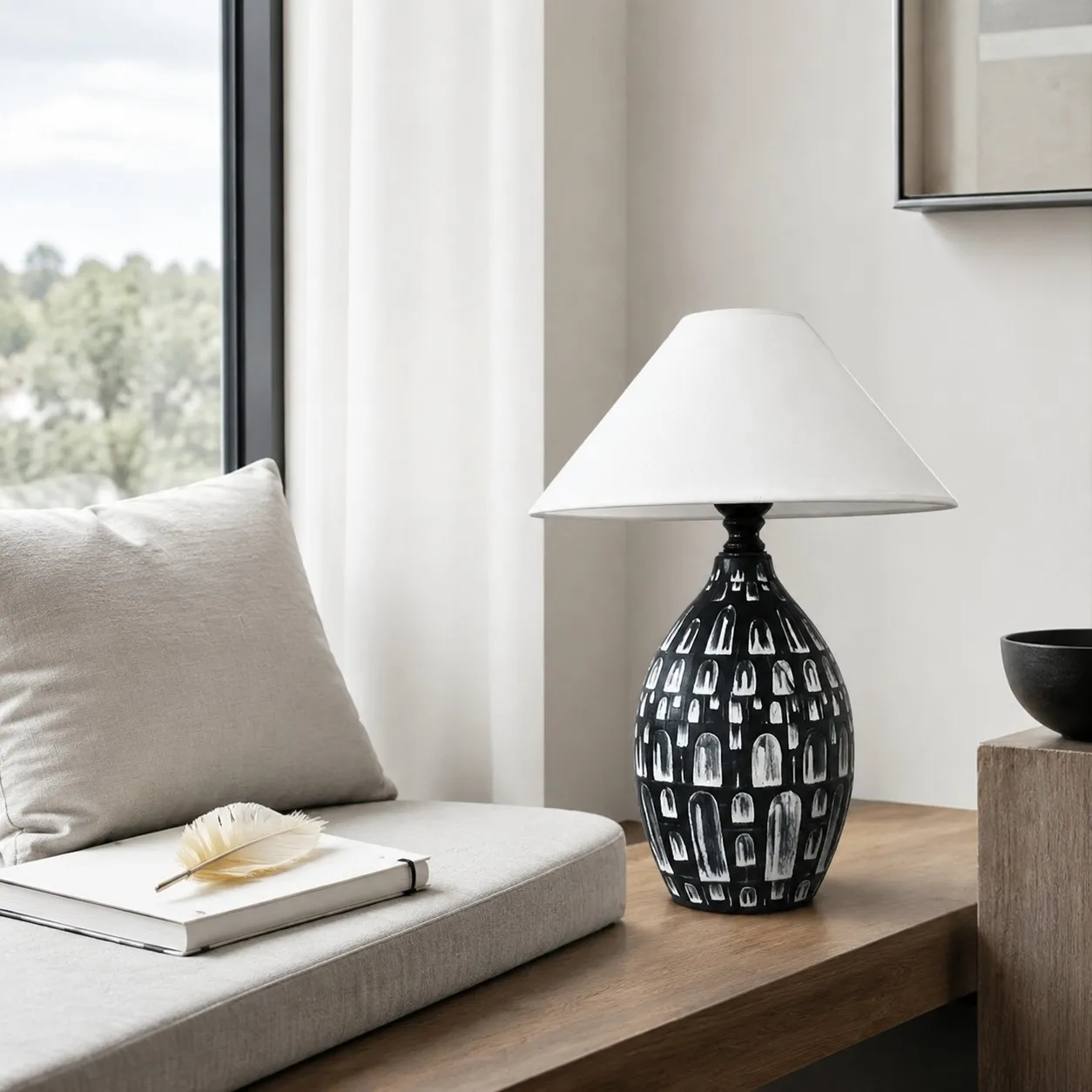 Ceramic table lamp beside a bright seating area