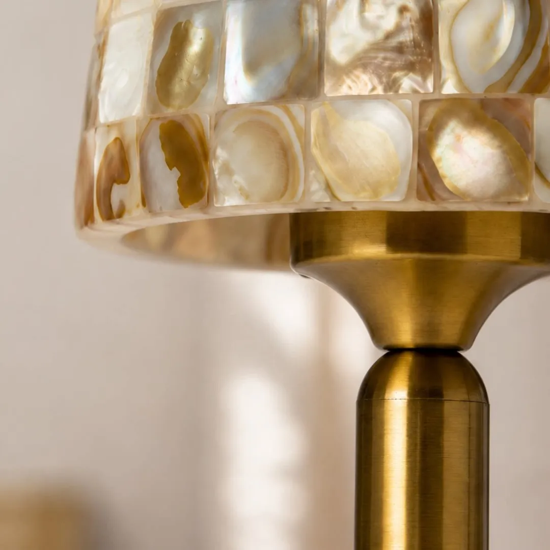 Close view of the shell shade edge and warm metal neck